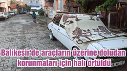Balıkesir'de araçların üzerine doludan korunmaları için halı örtüldü